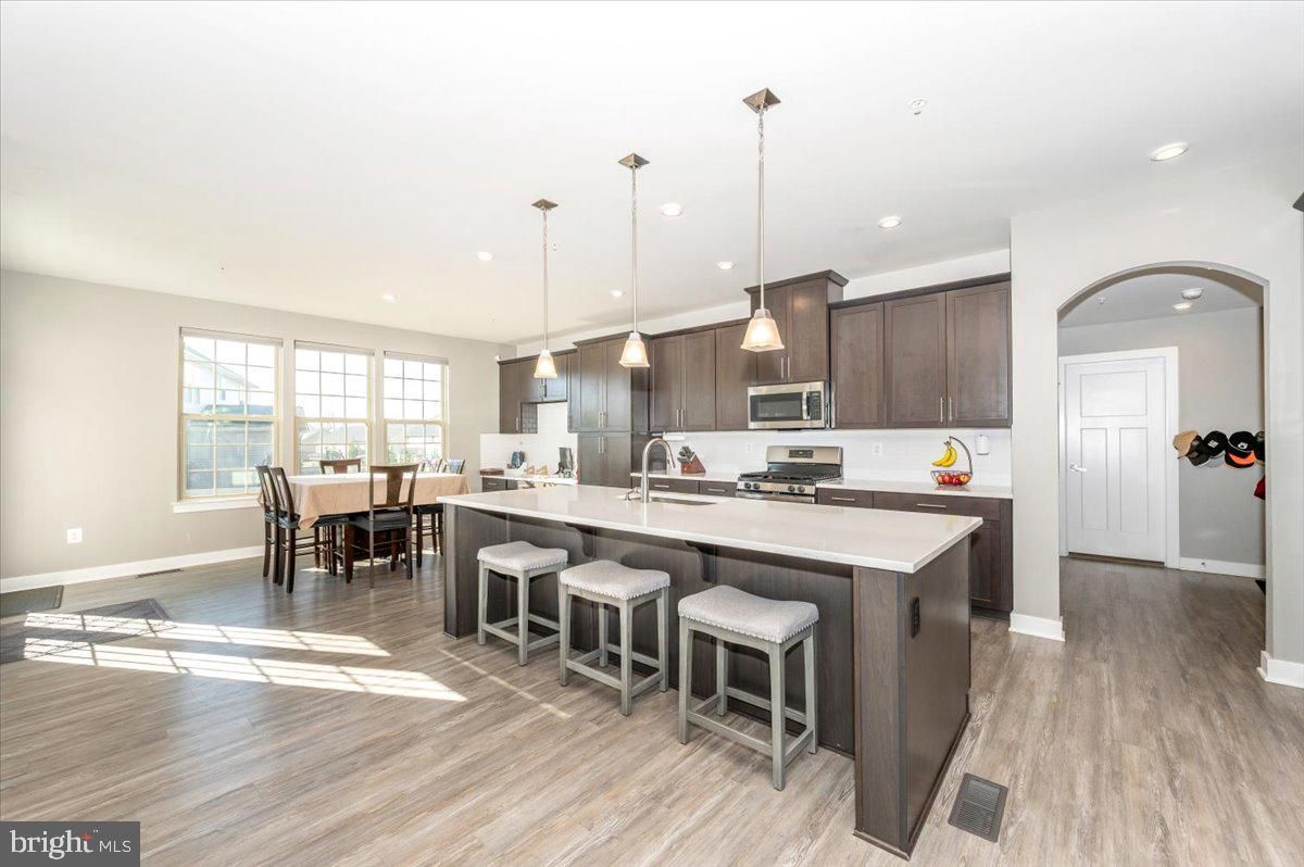 Dining room, Interior, Kitchen, Pendant Lights, Recessed Lighting, Stainless Steel Appliances, Wood Texture Flooring