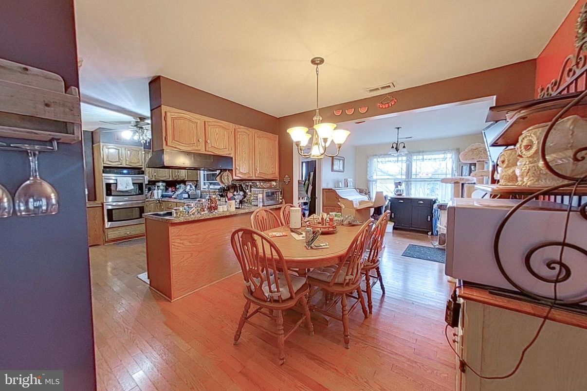 Chandelier, Dining room, Interior, Kitchen, Pendant Lights, Stainless Steel Appliances, Wood Texture Flooring