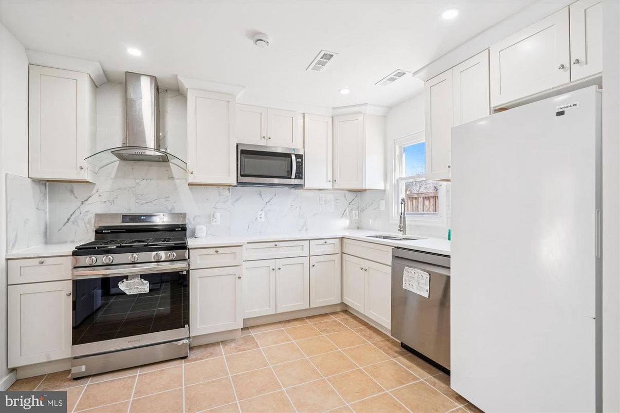 Interior, Kitchen, Marble Walls, Recessed Lighting, Stainless Steel Appliances