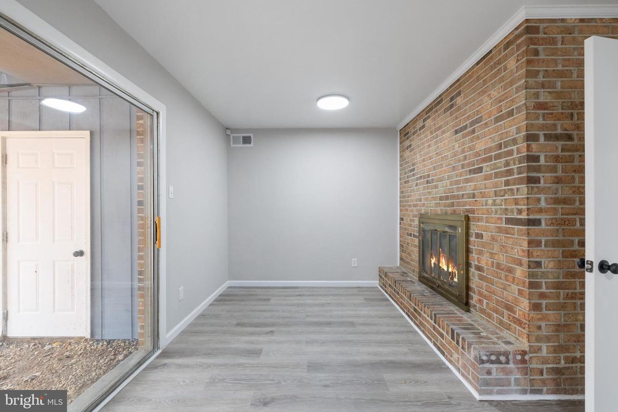 Empty room, Fireplace, Interior, Recessed Lighting, Stone Walls, Wood Texture Flooring