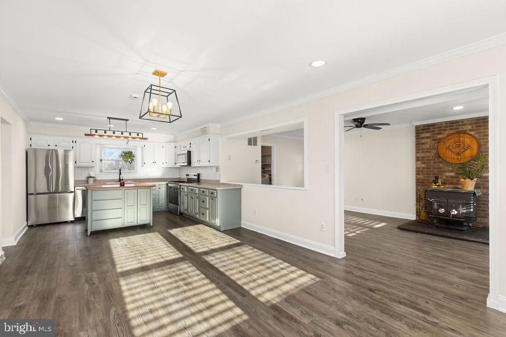 Fireplace, Interior, Kitchen, Pendant Lights, Recessed Lighting, Stainless Steel Appliances, Stone Walls, Wood Texture Flooring