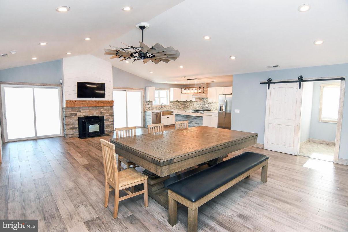 Dining room, Fireplace, Interior, Kitchen, Pendant Lights, Recessed Lighting, Stainless Steel Appliances, Wood Texture Flooring