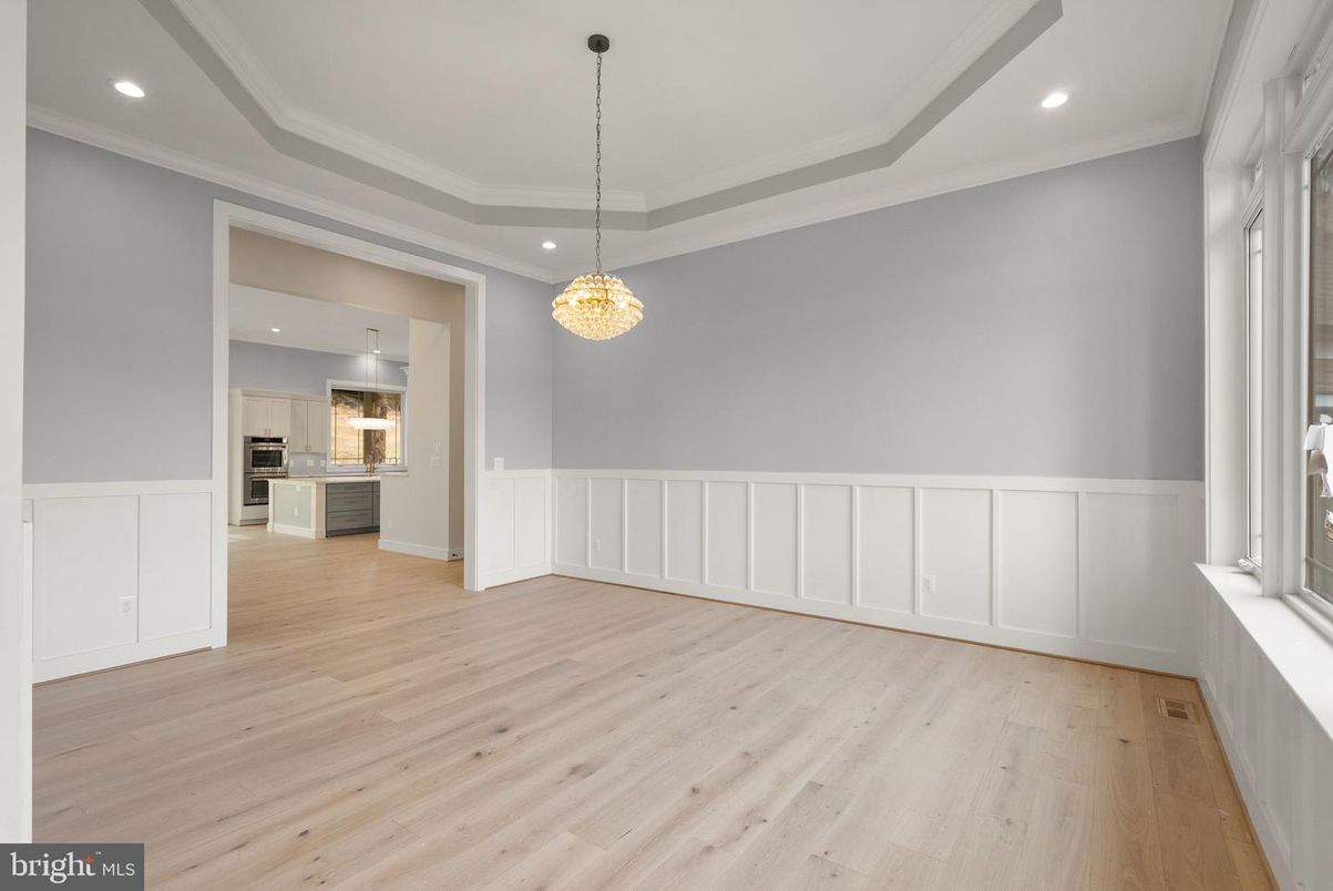 Chandelier, Empty room, Interior, Kitchen, Pendant Lights, Recessed Lighting, Stainless Steel Appliances, Wood Texture Flooring