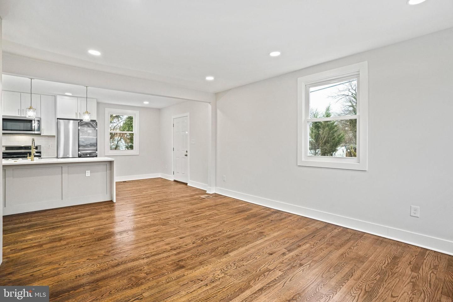 Empty room, Interior, Kitchen, Pendant Lights, Recessed Lighting, Stainless Steel Appliances, Wood Texture Flooring