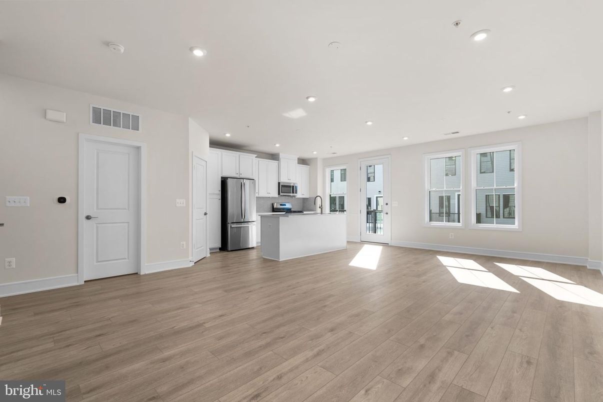 Empty room, Interior, Kitchen, Recessed Lighting, Stainless Steel Appliances, Wood Texture Flooring