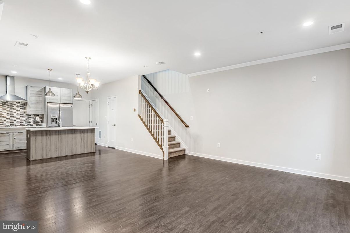 Chandelier, Empty room, Interior, Kitchen, Pendant Lights, Recessed Lighting, Stainless Steel Appliances, Wood Texture Flooring