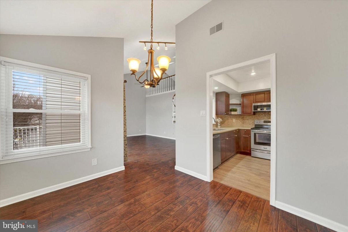 Chandelier, Empty room, Interior, Kitchen, Pendant Lights, Recessed Lighting, Stainless Steel Appliances, Wood Texture Flooring