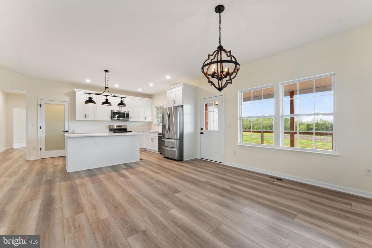 Chandelier, Empty room, Interior, Kitchen, Pendant Lights, Recessed Lighting, Stainless Steel Appliances, Wood Texture Flooring