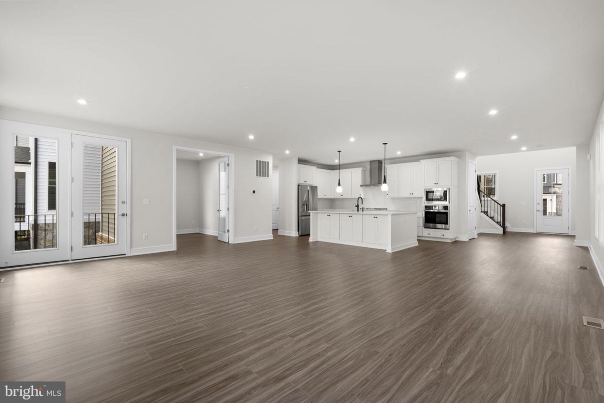 Empty room, Interior, Kitchen, Pendant Lights, Recessed Lighting, Stainless Steel Appliances, Wood Texture Flooring