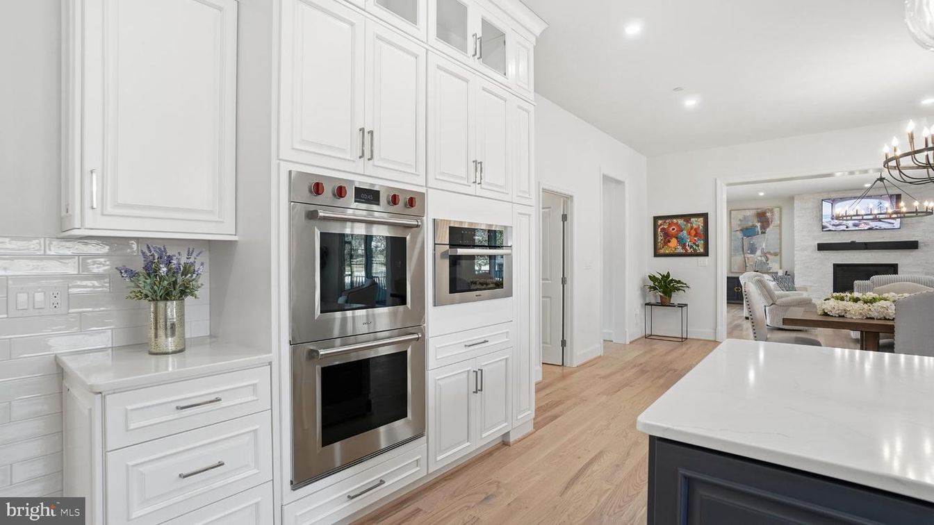 Dining room, Fireplace, Interior, Kitchen, Pendant Lights, Recessed Lighting, Stainless Steel Appliances, Stone Walls, Wood Texture Flooring