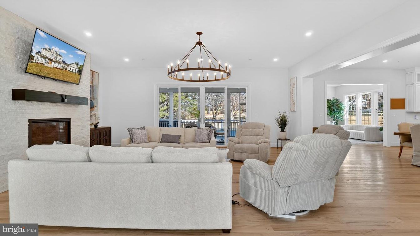 Chandelier, Fireplace, Interior, Living room, Recessed Lighting, Stone Walls, Wood Texture Flooring