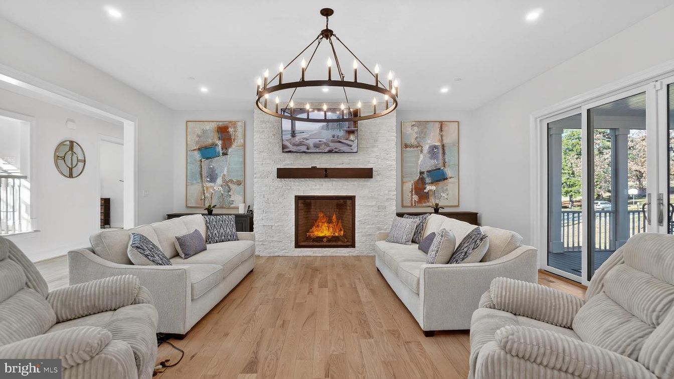 Chandelier, Fireplace, Interior, Living room, Recessed Lighting, Stone Walls, Wood Texture Flooring