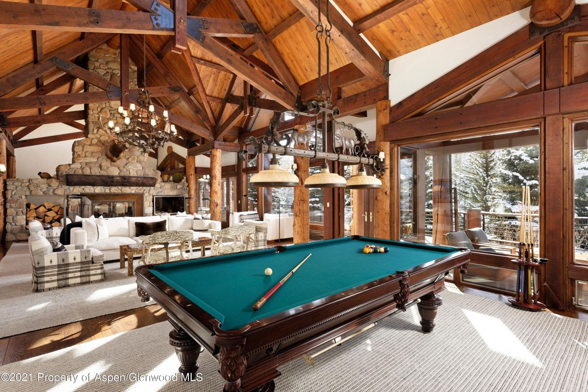 Billiard Table, Chandelier, Fireplace, Game Room, Interior, Living room, Pendant Lights, Stone Walls, Wooden Beams, Wooden Ceilings
