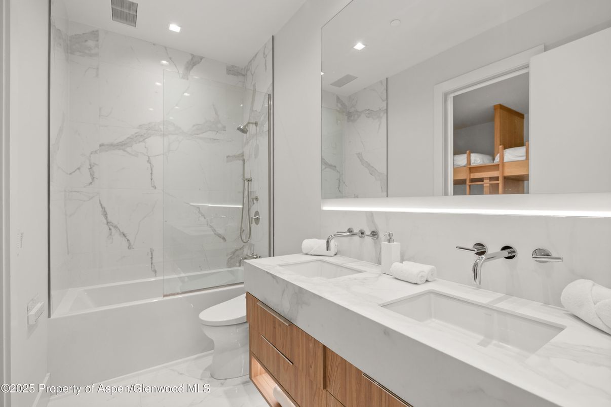 Bathroom, Dual Sink Vanities, Glass Shower, Interior, Marble, Marble Walls, Recessed Lighting