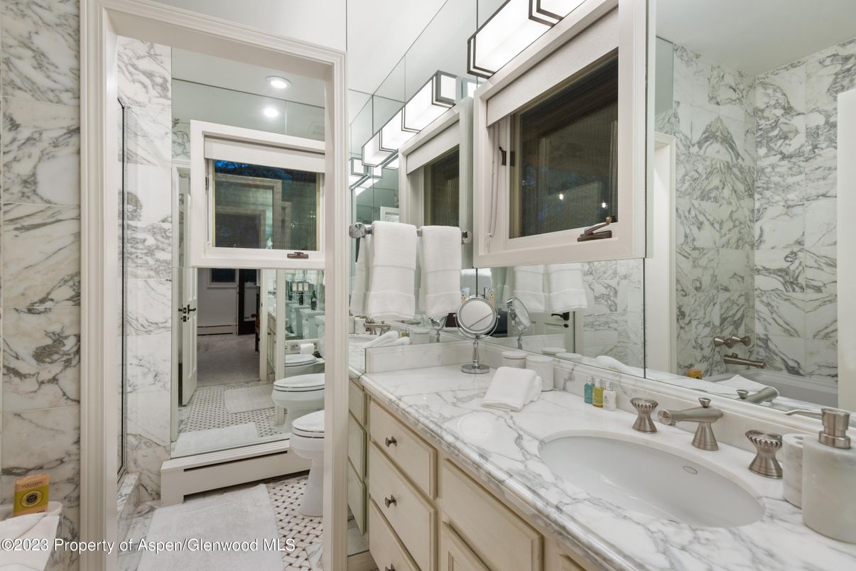 Bathroom, Dual Sink Vanities, Glass Shower, Interior, Marble Walls, Recessed Lighting