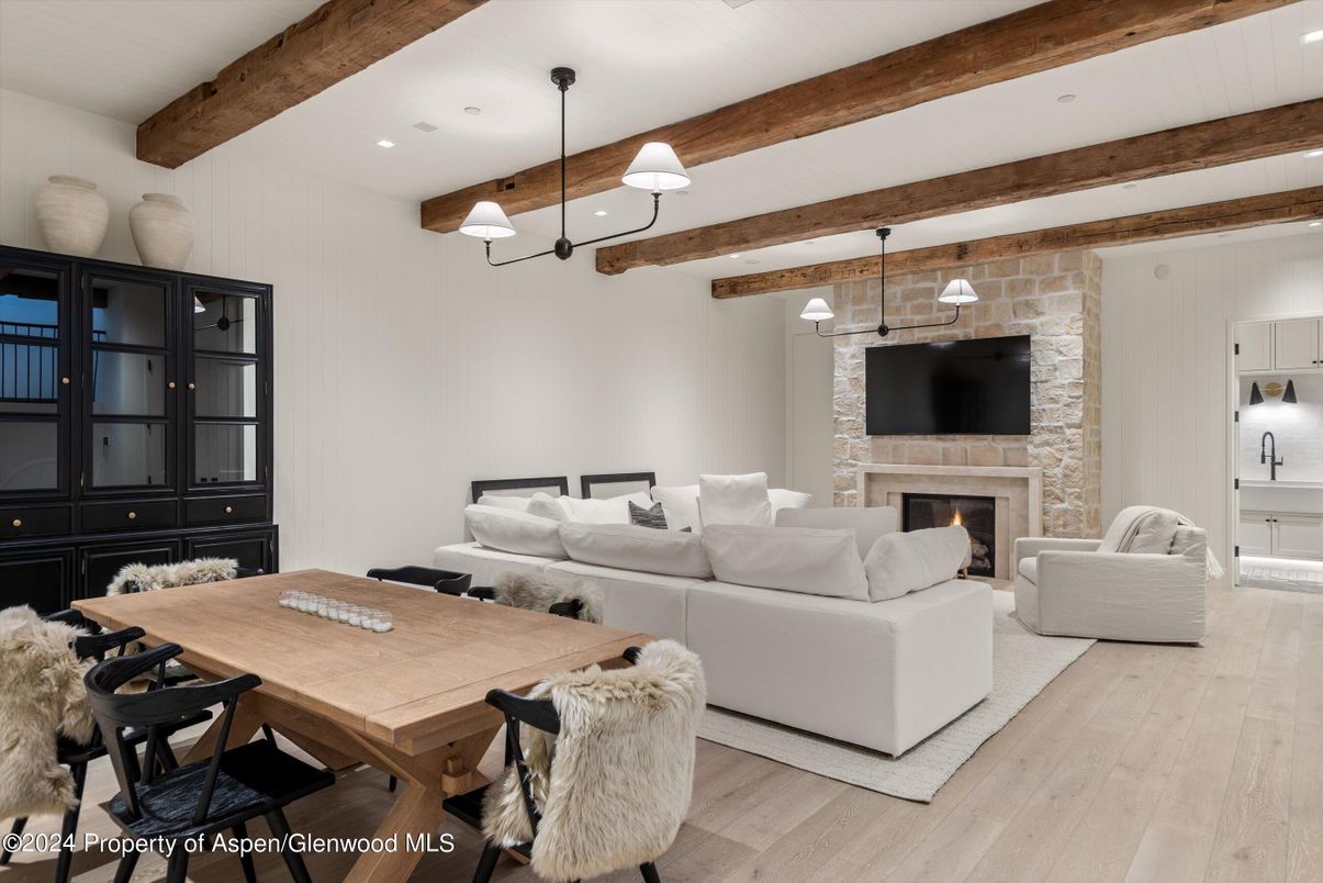 Dining room, Fireplace, Interior, Living room, Pendant Lights, Recessed Lighting, Stone Walls, Wooden Beams, Wood Texture Flooring