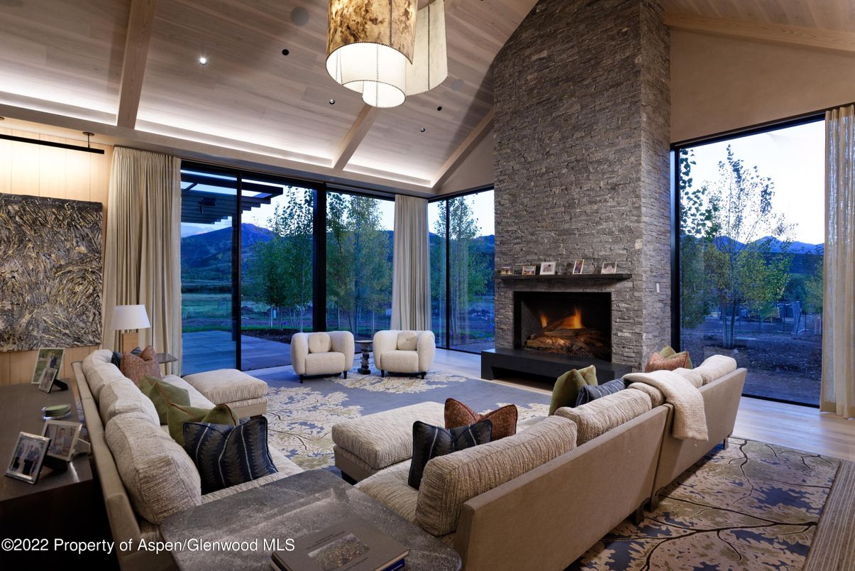 Chandelier, Fireplace, Interior, Living room, Recessed Lighting, Stone Walls, Wooden Ceilings, Wood Texture Flooring