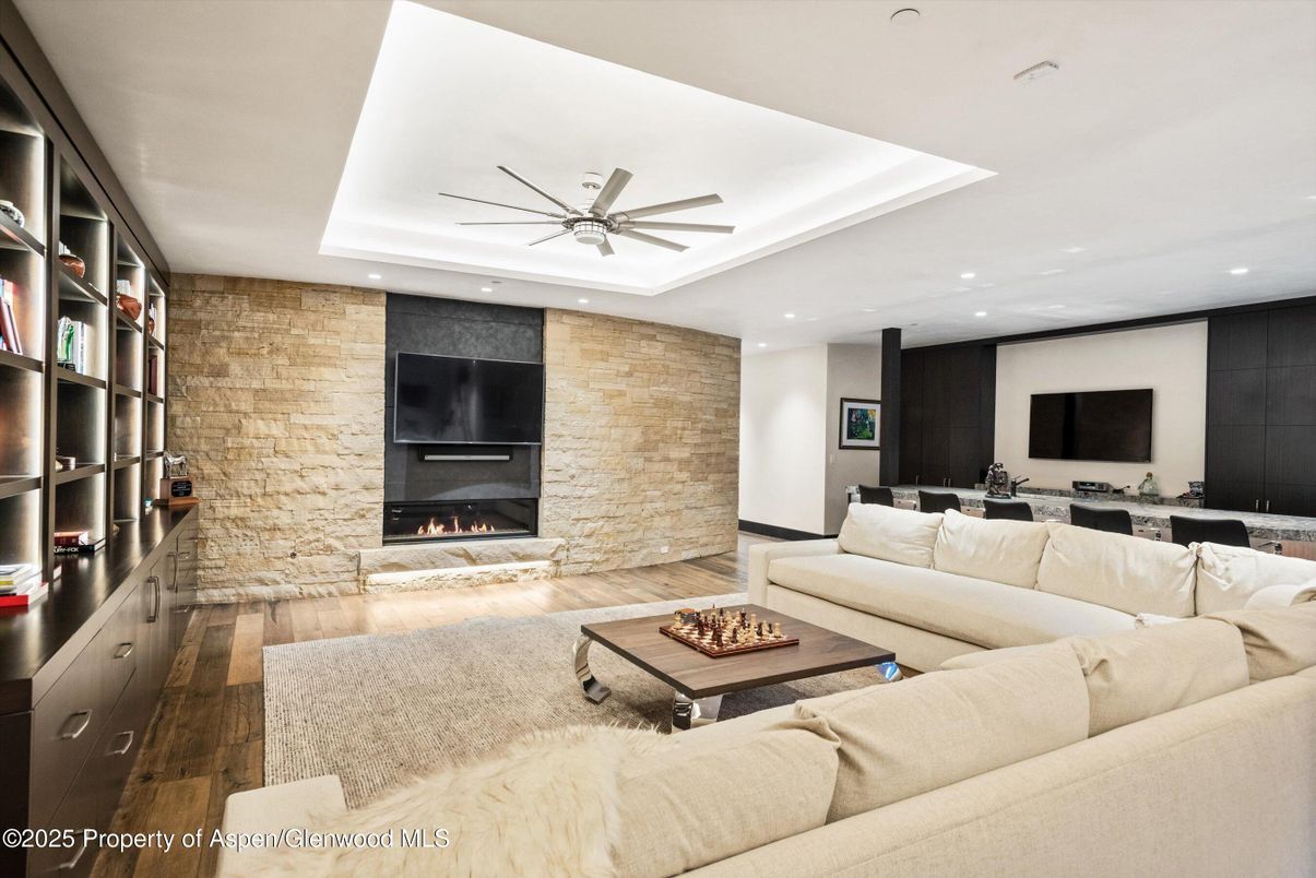Fireplace, Interior, Living room, Recessed Lighting, Stone Walls, Wood Texture Flooring