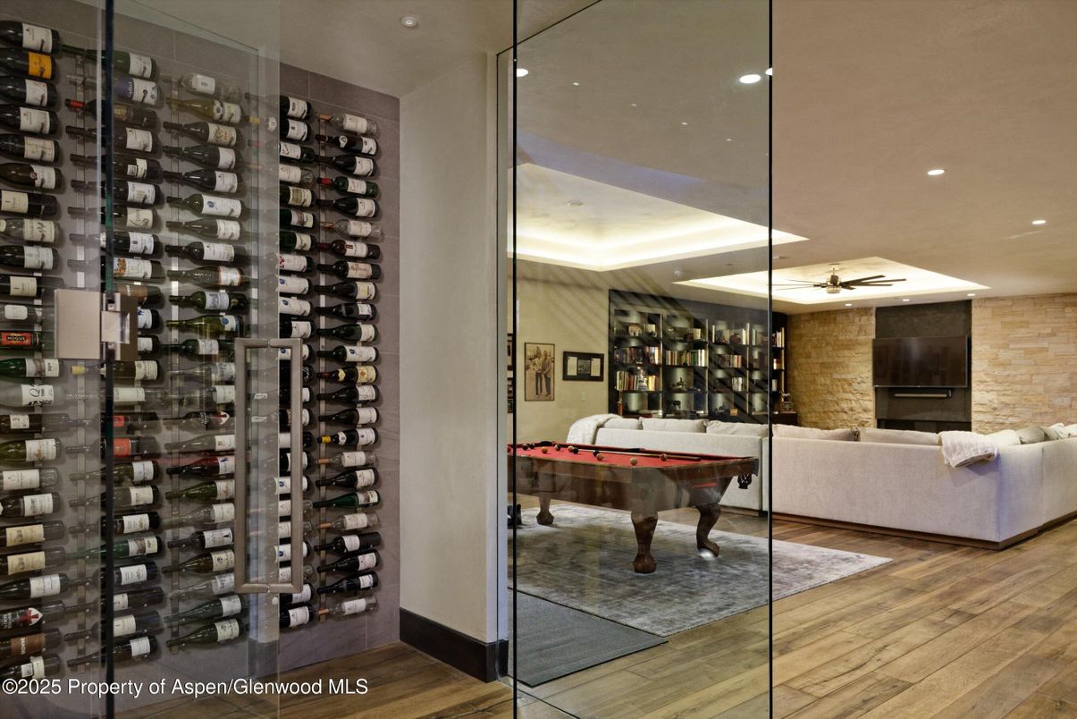 Billiard Table, Fireplace, Game Room, Interior, Recessed Lighting, Stone Walls, Wine Storage, Wood Texture Flooring
