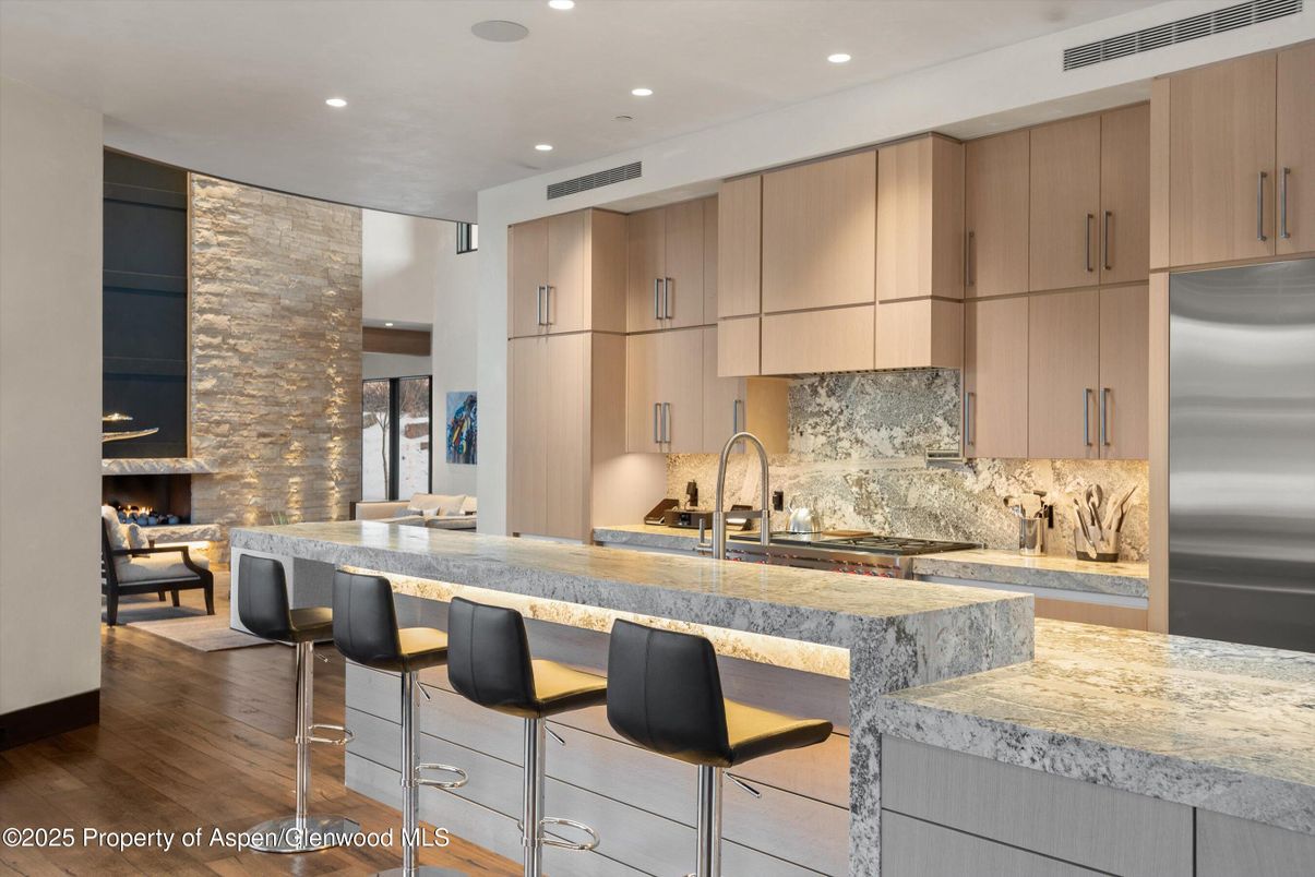 Fireplace, Interior, Kitchen, Recessed Lighting, Stainless Steel Appliances, Stone Walls, Wood Texture Flooring