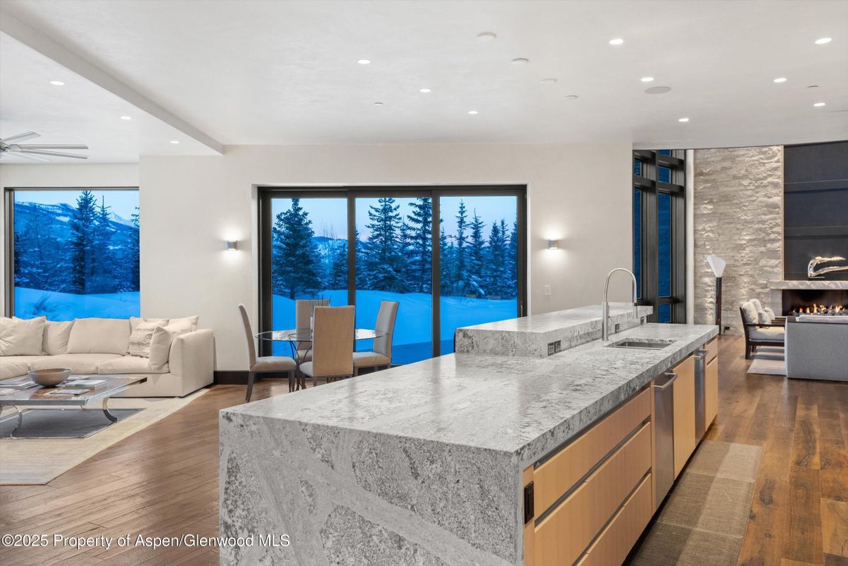 Dining room, Fireplace, Interior, Kitchen, Living room, Recessed Lighting, Stone Walls, Wood Texture Flooring