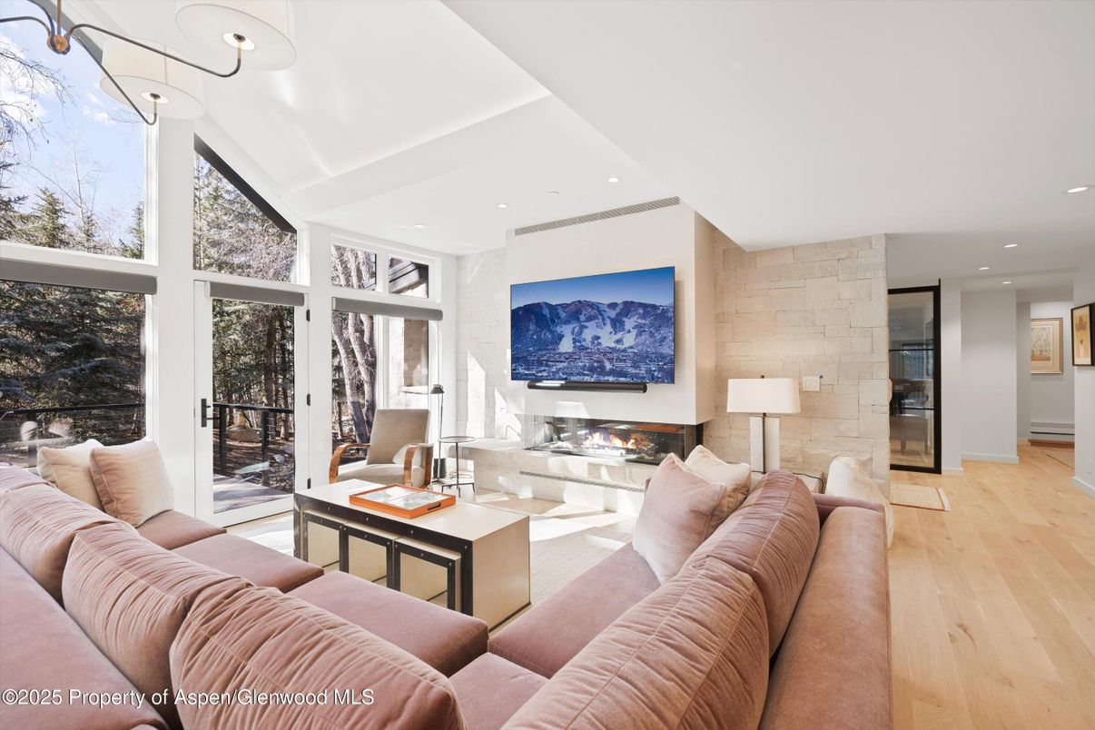 Fireplace, Interior, Living room, Recessed Lighting, Stone Walls, Wood Texture Flooring