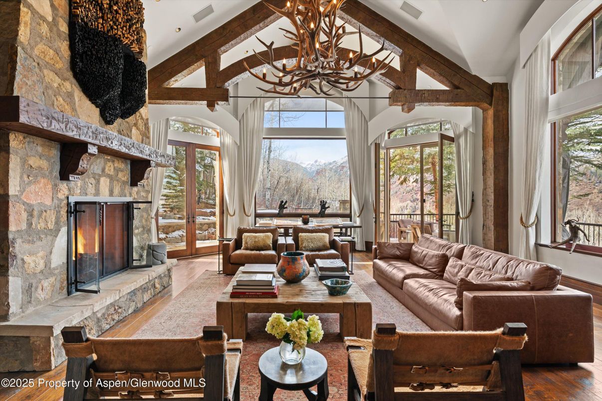 Chandelier, Fireplace, Interior, Living room, Recessed Lighting, Stone Walls, Wooden Beams, Wood Texture Flooring