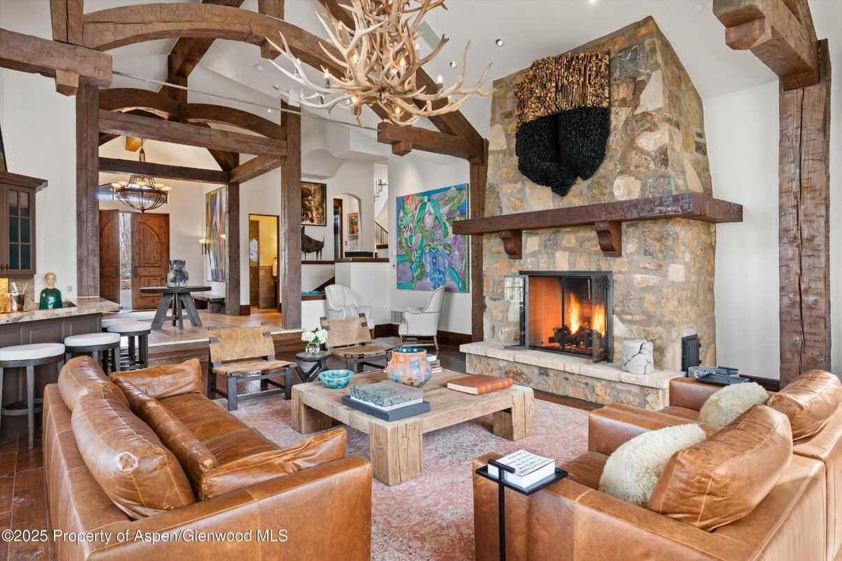 Chandelier, Dining room, Fireplace, Interior, Living room, Recessed Lighting, Stone Walls, Wooden Beams