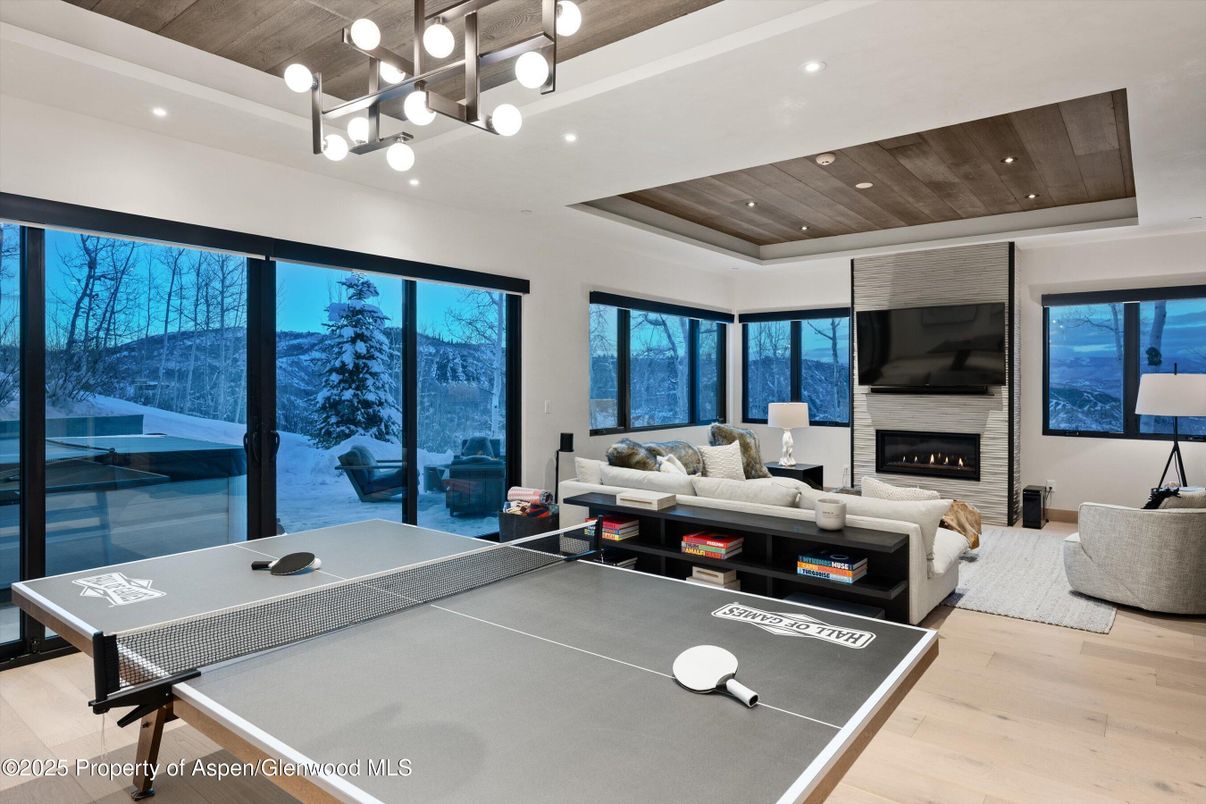 Fireplace, Game Room, Interior, Living room, Pendant Lights, Recessed Lighting, Wooden Ceilings, Wood Texture Flooring