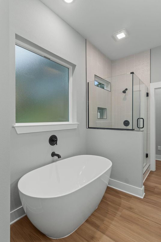 Bathroom, Free Standing Baths, Glass Shower, Interior, Recessed Lighting, Wood Texture Flooring