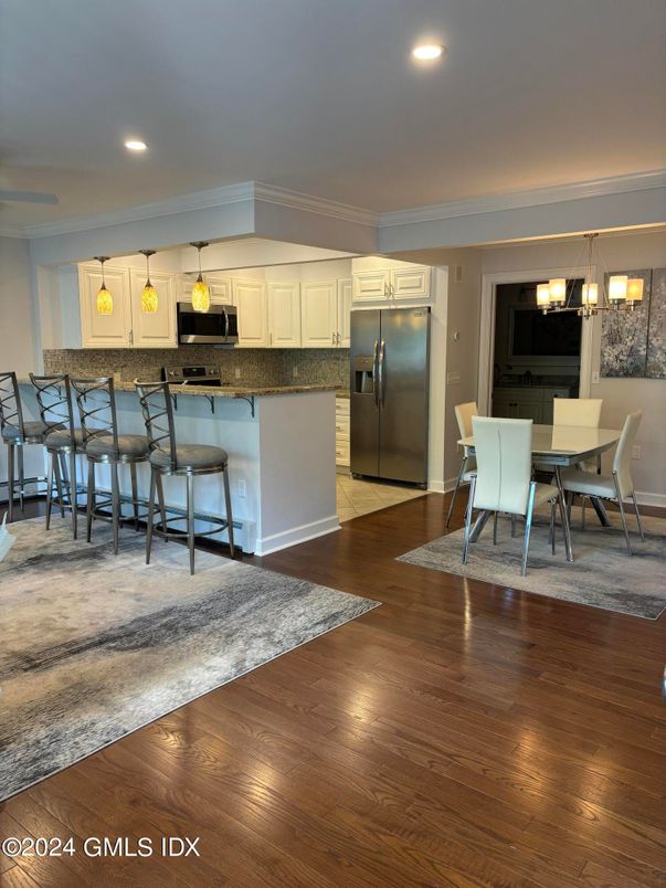 Dining room, Interior, Kitchen, Pendant Lights, Recessed Lighting, Stainless Steel Appliances, Wood Texture Flooring