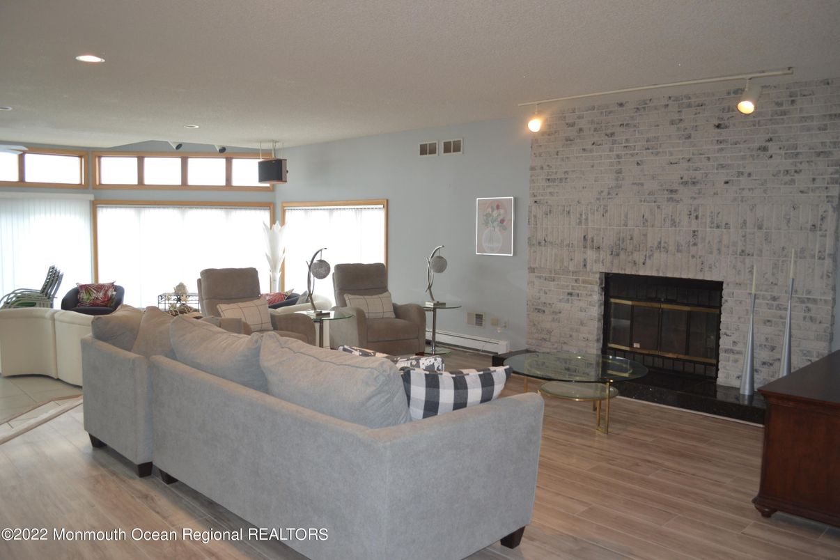 Fireplace, Interior, Living room, Recessed Lighting, Stone Walls, Wood Texture Flooring