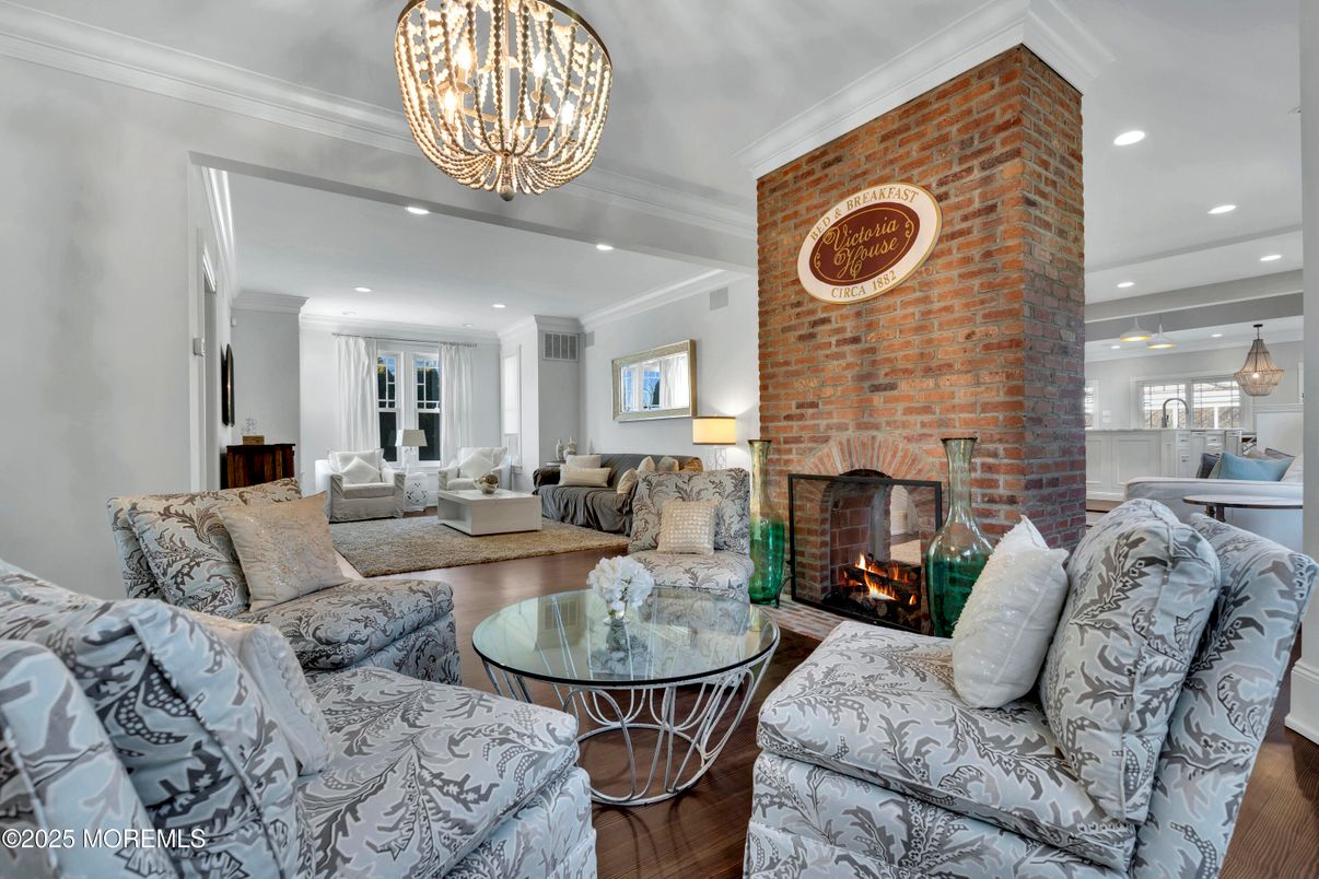 Chandelier, Fireplace, Interior, Living room, Pendant Lights, Recessed Lighting, Stone Walls, Wood Texture Flooring