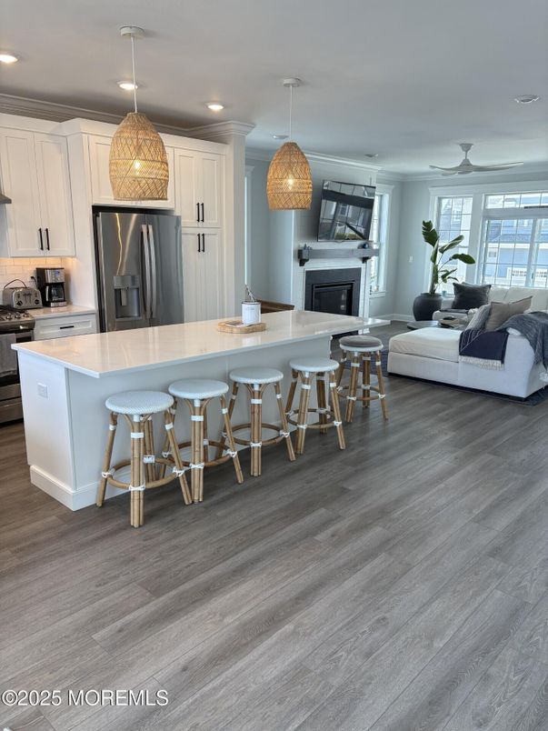 Fireplace, Interior, Kitchen, Living room, Pendant Lights, Recessed Lighting, Stainless Steel Appliances, Wood Texture Flooring