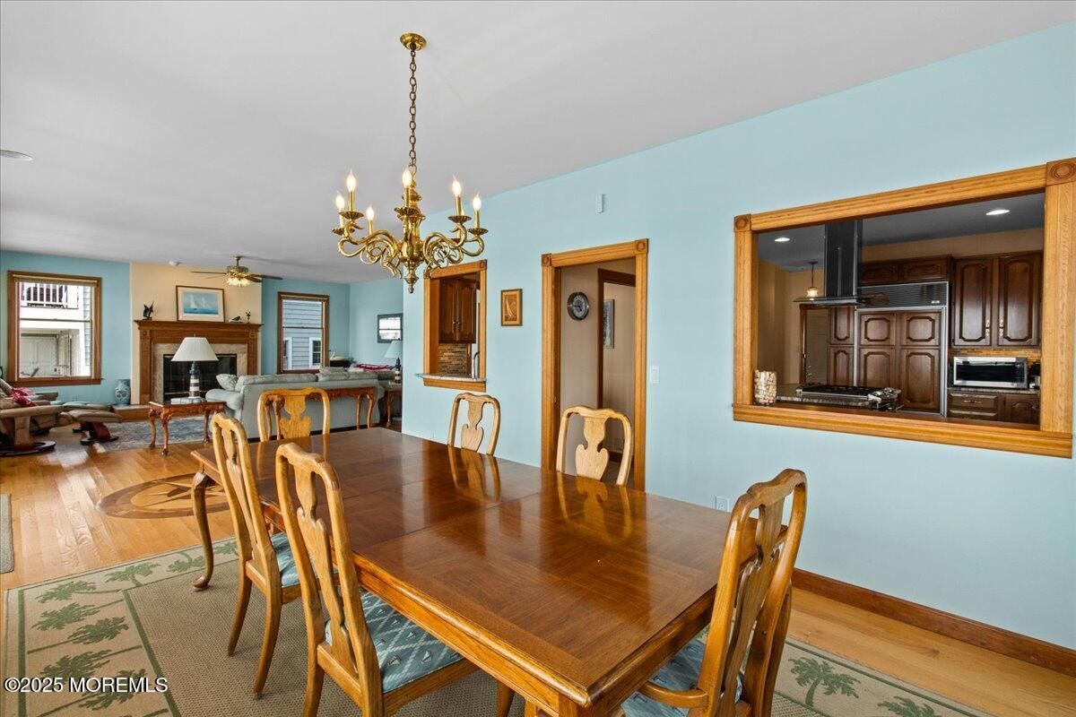 Chandelier, Dining room, Fireplace, Interior, Kitchen, Living room, Recessed Lighting, Wood Texture Flooring