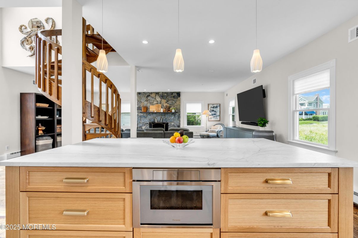 Fireplace, Interior, Kitchen, Pendant Lights, Recessed Lighting, Stainless Steel Appliances, Stone Walls