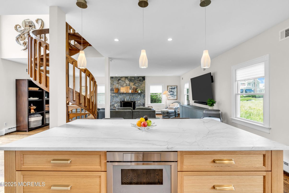 Fireplace, Interior, Kitchen, Pendant Lights, Recessed Lighting, Stainless Steel Appliances, Stone Walls