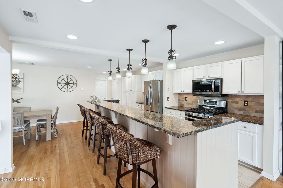 Dining room, Interior, Kitchen, Pendant Lights, Recessed Lighting, Stainless Steel Appliances, Wood Texture Flooring