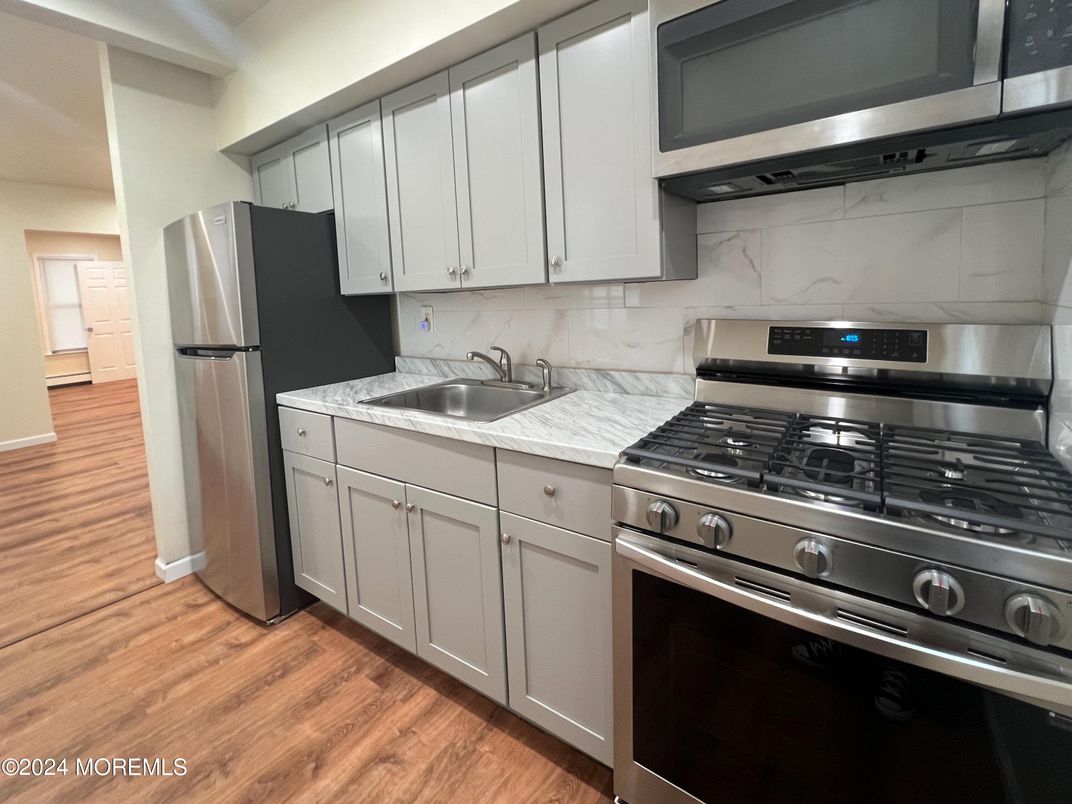 Interior, Kitchen, Marble Walls, Stainless Steel Appliances, Wood Texture Flooring