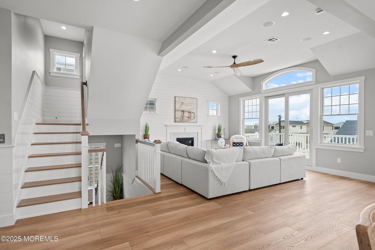 Fireplace, Interior, Living room, Recessed Lighting, Stone Walls, Water, Wood Texture Flooring