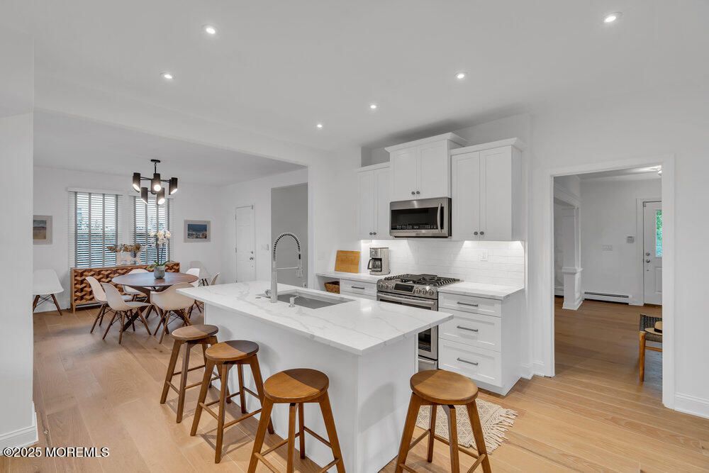 Dining room, Interior, Kitchen, Pendant Lights, Recessed Lighting, Stainless Steel Appliances, Wood Texture Flooring