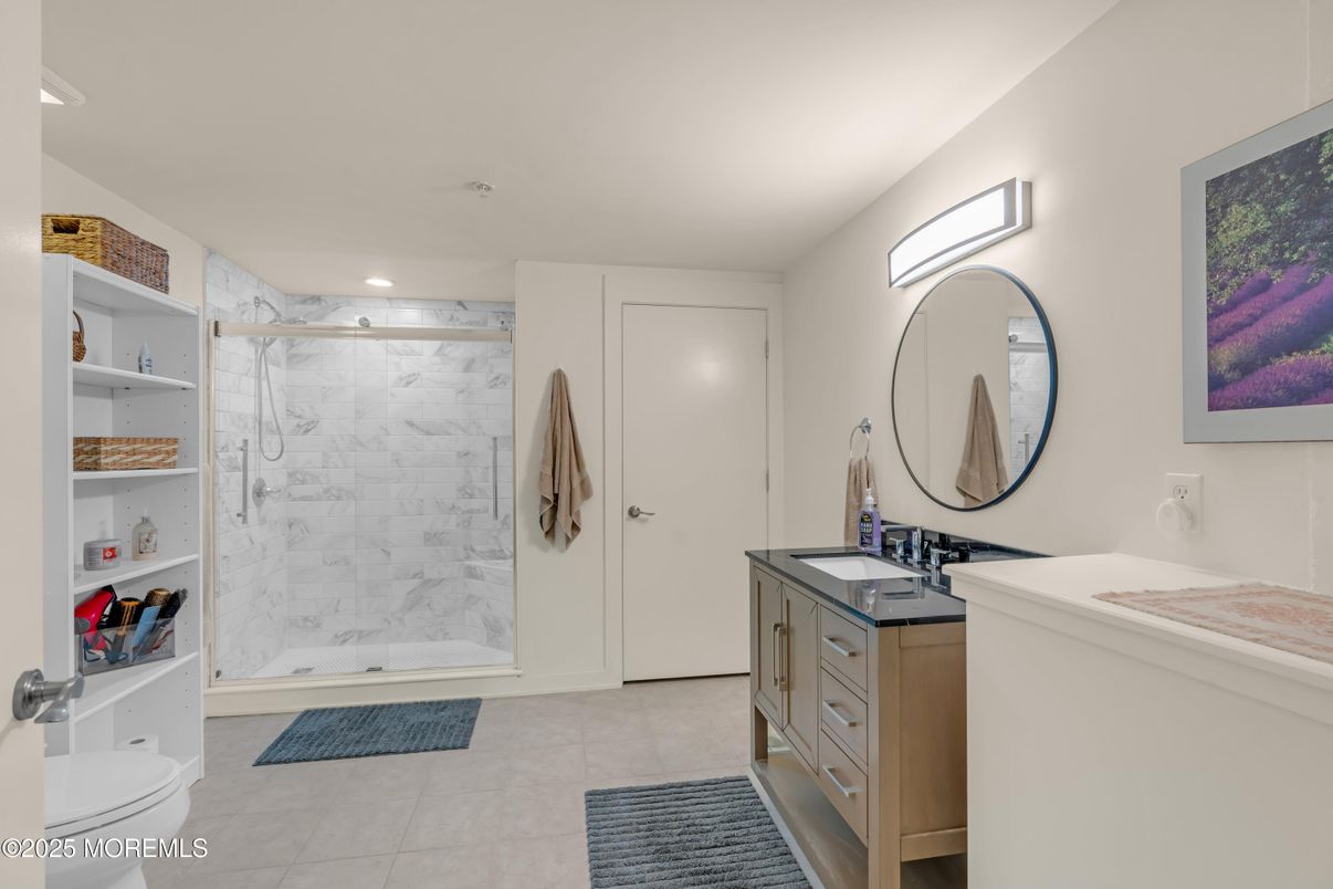 Bathroom, Dual Sink Vanities, Glass Shower, Interior, Marble Walls, Recessed Lighting