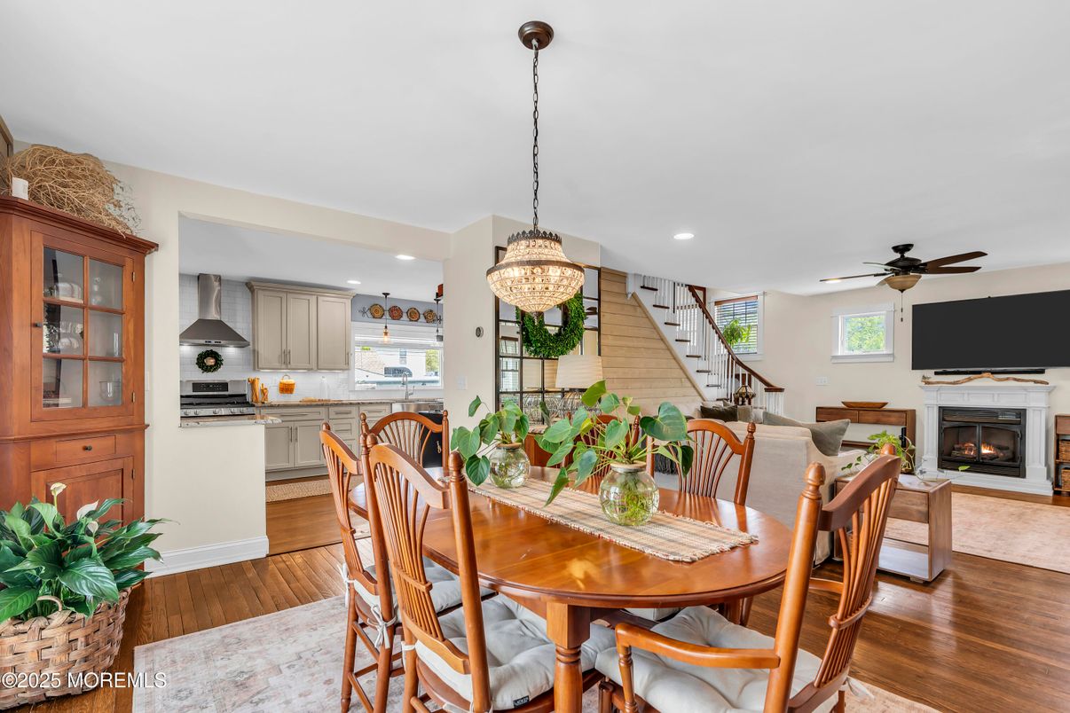 Chandelier, Dining room, Fireplace, Interior, Kitchen, Pendant Lights, Recessed Lighting, Stainless Steel Appliances, Wood Texture Flooring