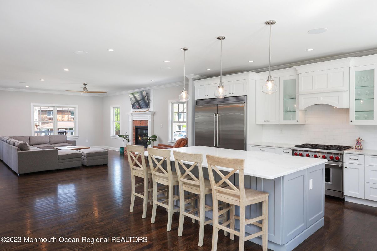 Dining room, Fireplace, Interior, Kitchen, Living room, Pendant Lights, Recessed Lighting, Stainless Steel Appliances, Wood Texture Flooring