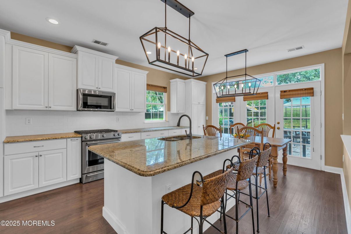 Chandelier, Dining room, Interior, Kitchen, Pendant Lights, Recessed Lighting, Stainless Steel Appliances, Wood Texture Flooring