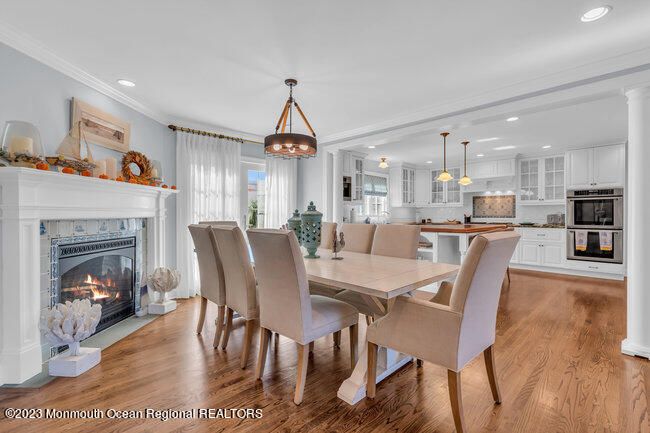Dining room, Fireplace, Interior, Kitchen, Pendant Lights, Recessed Lighting, Stainless Steel Appliances, Wood Texture Flooring