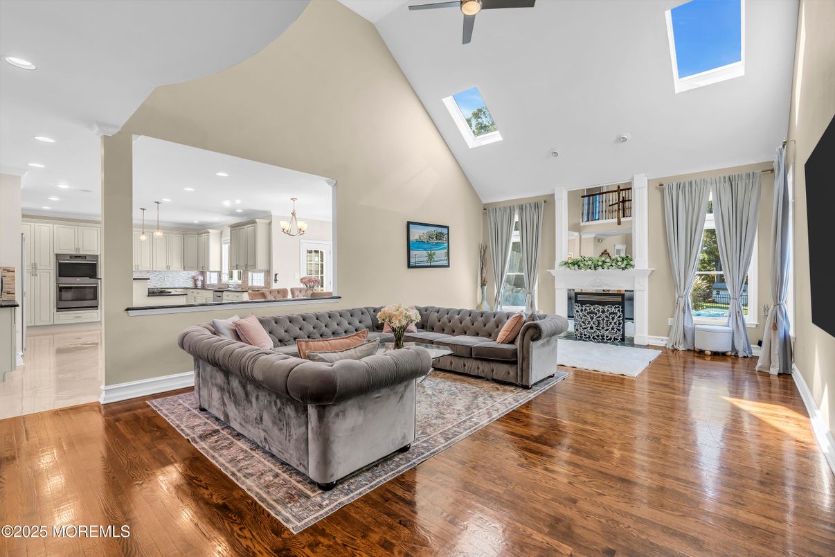 Chandelier, Dining room, Fireplace, Interior, Kitchen, Living room, Recessed Lighting, Stainless Steel Appliances, Wood Texture Flooring