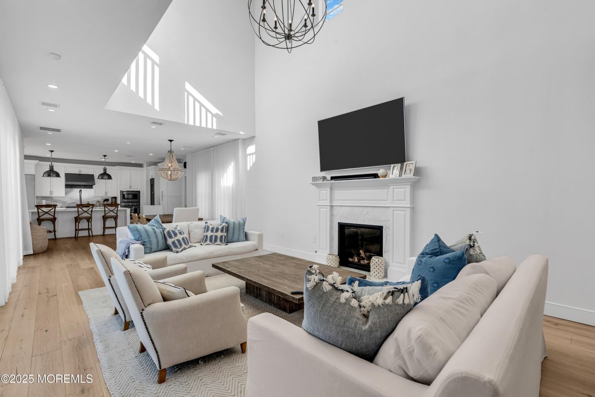 Chandelier, Fireplace, Interior, Kitchen, Living room, Pendant Lights, Recessed Lighting, Wood Texture Flooring