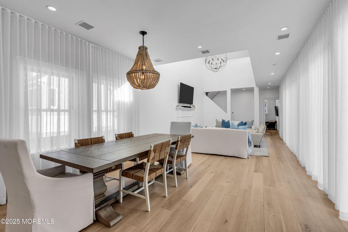 Chandelier, Dining room, Fireplace, Interior, Living room, Pendant Lights, Recessed Lighting, Wood Texture Flooring