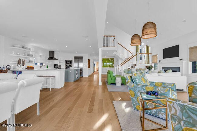 Dining room, Fireplace, Interior, Kitchen, Pendant Lights, Recessed Lighting, Stainless Steel Appliances, Wood Texture Flooring